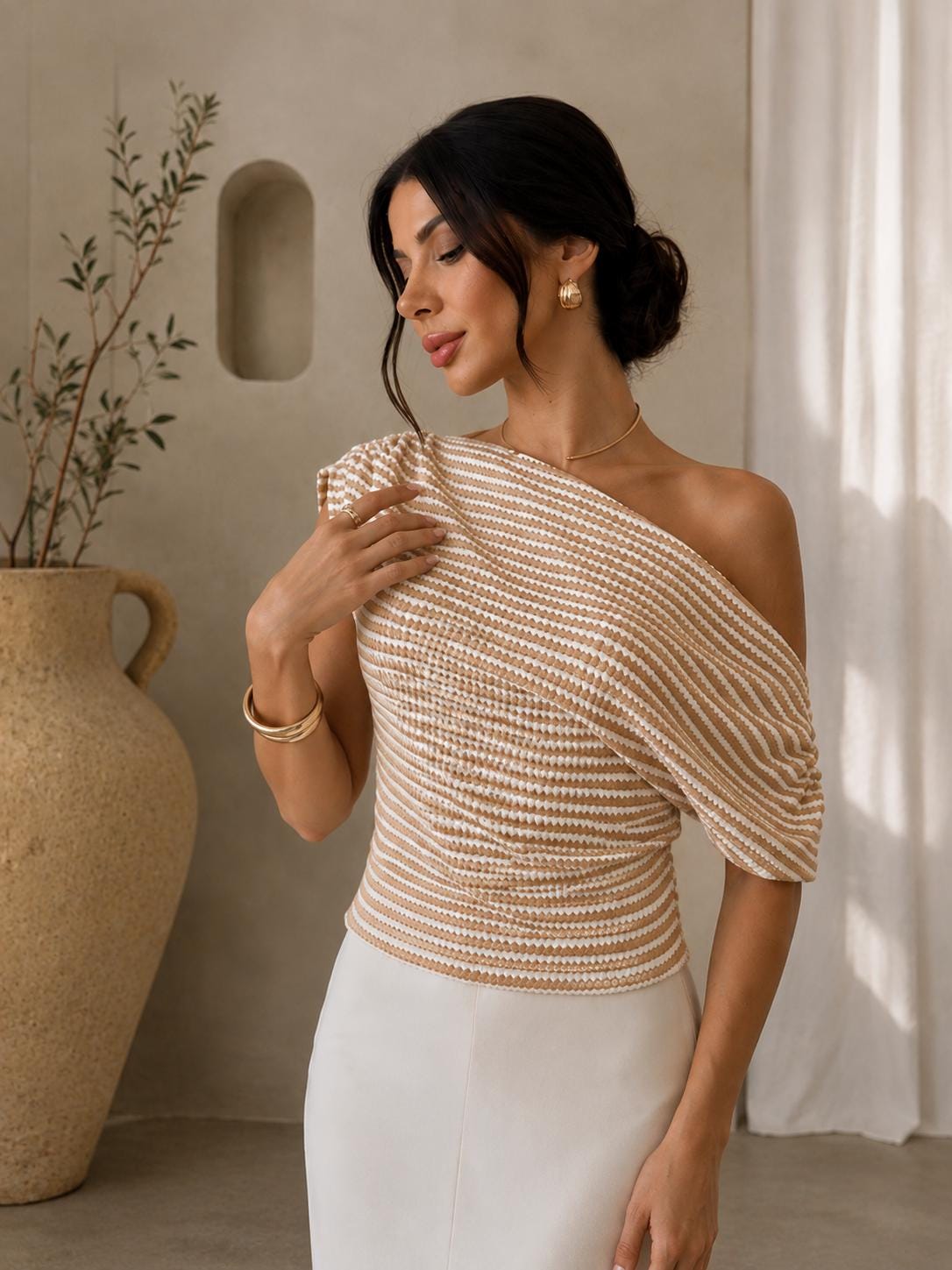 May include: A one-shoulder top featuring a horizontal striped pattern in tan and white. The garment has a draped, gathered neckline that extends into a single short sleeve, creating a textured, ribbed appearance across the fitted bodice.